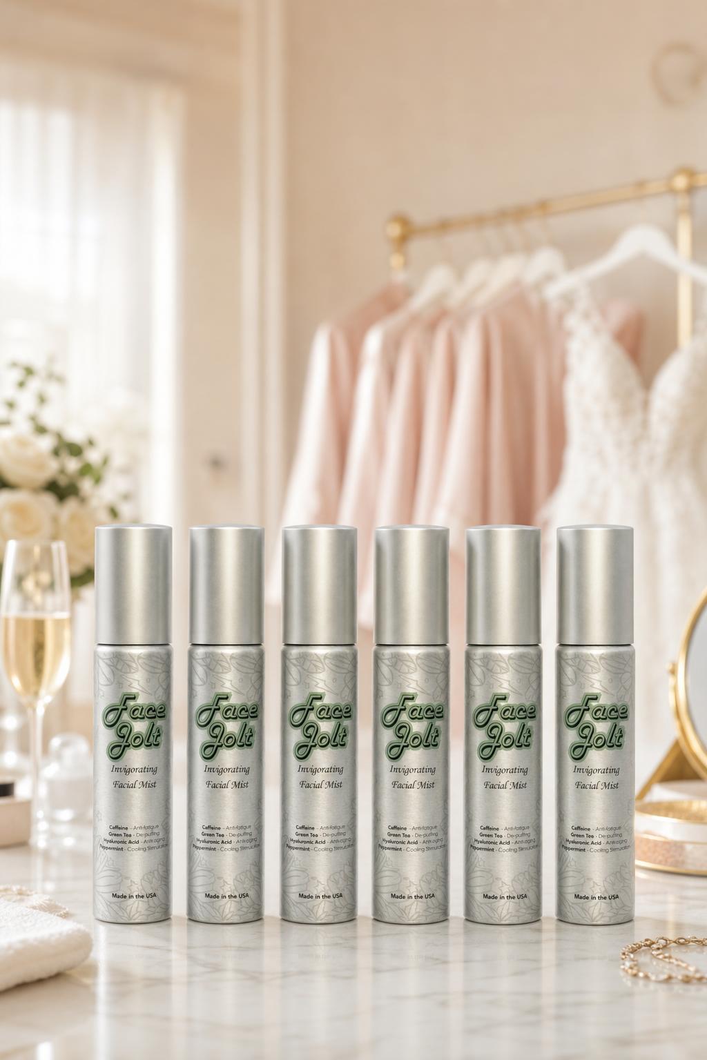 Face Jolt bridal party gift set — six caffeine facial mist bottles on a marble vanity with bridesmaid robes and wedding dress, bridesmaid gift idea
