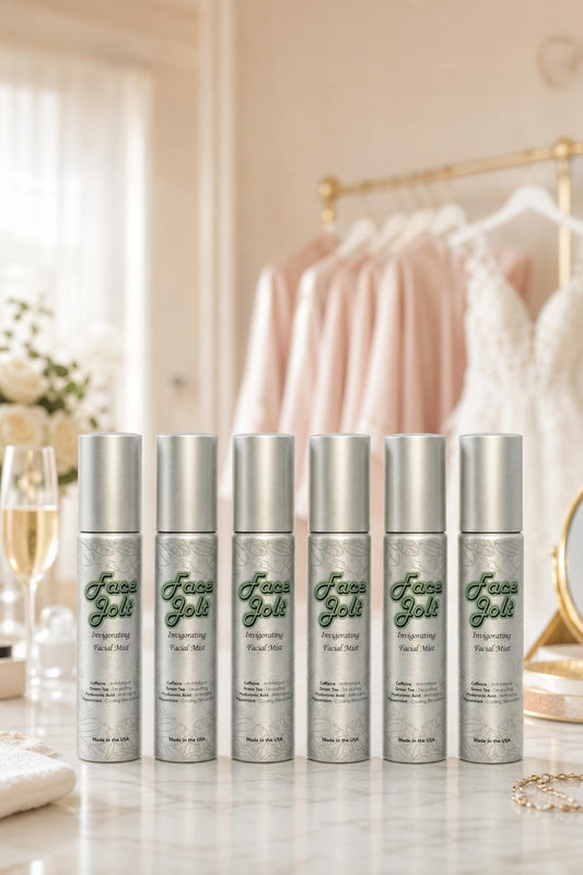 Face Jolt bridal party gift set — six caffeine facial mist bottles on a marble vanity with bridesmaid robes and wedding dress, bridesmaid gift idea